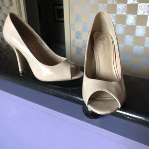 Cream colored patent open toe pumps